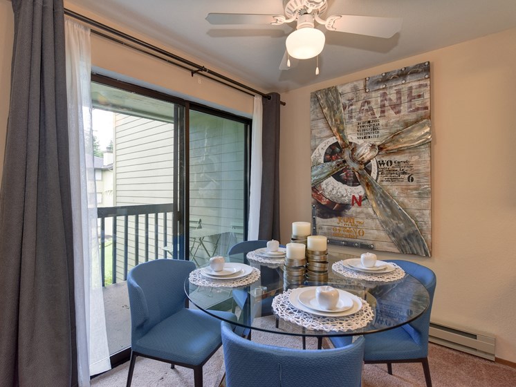 Dining Area with View of Private Patio, Blue Chairs, Ceiling Fan/Light